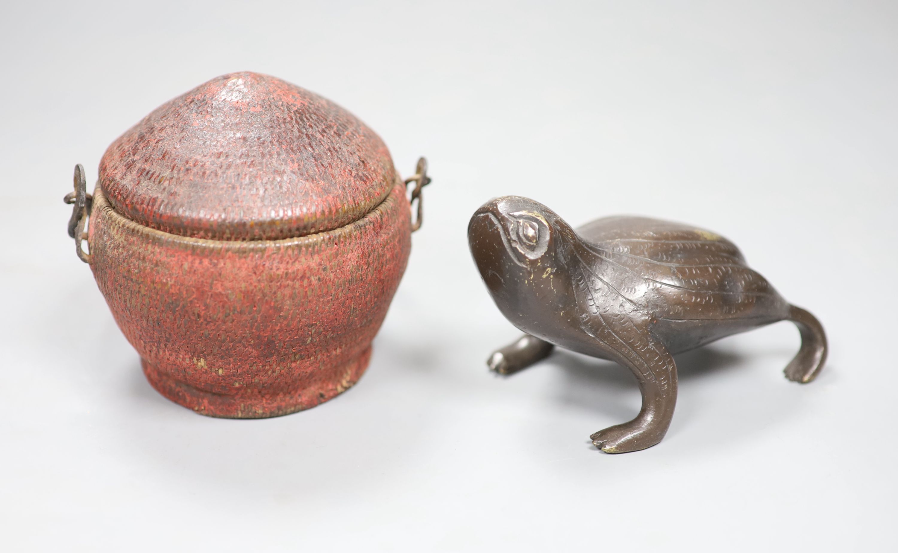 A Chinese bronze toad, a wood figure of an immortal and a woven basket and cover